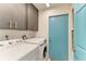 Bright laundry room with front loading washer and dryer and upper cabinets for ample storage at 1008 83Rd Nw St, Bradenton, FL 34209