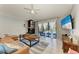 Inviting living room with fireplace, plush leather sofa, and sliding glass doors leading to the pool area at 1008 83Rd Nw St, Bradenton, FL 34209