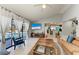 Bright living area with tile floors, comfortable seating, and a view of the pool through sliding glass doors at 1008 83Rd Nw St, Bradenton, FL 34209