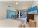 Serene main bedroom boasting a view of the pool, private workspace, and stylish blue doors to a private retreat at 1008 83Rd Nw St, Bradenton, FL 34209