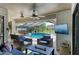 Inviting outdoor living space with comfortable seating, ceiling fans, and a view of the pool and landscape at 1008 83Rd Nw St, Bradenton, FL 34209