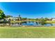 Lush pond reflecting the clear blue sky and surrounding houses, perfect for nature lovers at 1008 83Rd Nw St, Bradenton, FL 34209