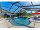 Stunning screened-in pool and spa area with comfortable seating and lush landscaping at 1008 83Rd Nw St, Bradenton, FL 34209