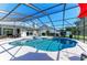 Sparkling pool within a screened enclosure, featuring a spa, outdoor seating, and lush landscaping at 1008 83Rd Nw St, Bradenton, FL 34209