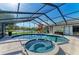Screened in pool and spa with lake view, lounge chairs and summer accessories at 1008 83Rd Nw St, Bradenton, FL 34209