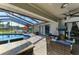 Spacious outdoor patio featuring a pool, comfortable seating, and a view of the lush landscape at 1008 83Rd Nw St, Bradenton, FL 34209