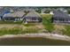 An aerial view of a neighborhood with a lake and fenced backyards at 11713 Chevelon Ln, Parrish, FL 34219