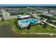 Aerial view of neighborhood pool and amenity center beside a pond at 11713 Chevelon Ln, Parrish, FL 34219