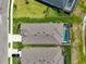 Aerial view of a well-maintained home with a private pool, fenced yard, and lush landscaping at 11713 Chevelon Ln, Parrish, FL 34219