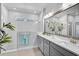 Bright bathroom featuring a glass-enclosed shower, and modern double vanity with two sinks at 11713 Chevelon Ln, Parrish, FL 34219