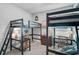 A bedroom features dark bunk beds, a desk area, and artwork on the walls at 11713 Chevelon Ln, Parrish, FL 34219
