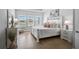 Serene bedroom featuring a white bed frame, hardwood floors, and plenty of natural light at 11713 Chevelon Ln, Parrish, FL 34219