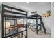 Bedroom featuring dark bunk beds, coastal artwork, and desk areas for children at 11713 Chevelon Ln, Parrish, FL 34219