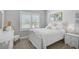 Cozy bedroom with white furniture, soft textiles, and a calm atmosphere for restful sleep at 11713 Chevelon Ln, Parrish, FL 34219