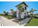 The Riverfield community building shows modern architecture with a stylish tower and lush landscaping at 11713 Chevelon Ln, Parrish, FL 34219