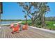 A serene deck view showcases stylish outdoor seating with a scenic pond backdrop at 11713 Chevelon Ln, Parrish, FL 34219