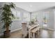 Cozy dining room with a wooden table, bench seating, plantation shutters, and ample natural light at 11713 Chevelon Ln, Parrish, FL 34219