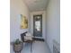 Inviting entryway with a welcome chair, stylish decor, and bright natural light at 11713 Chevelon Ln, Parrish, FL 34219