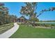 A lovely clubhouse exterior with a lush lawn, walkway, and serene water view at 11713 Chevelon Ln, Parrish, FL 34219