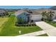 Charming single Gathering home with lush landscaping, a well-manicured lawn, and a two-car garage at 11713 Chevelon Ln, Parrish, FL 34219