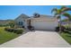 Charming single-story home with a well-manicured lawn, large driveway, and a two-car garage at 11713 Chevelon Ln, Parrish, FL 34219