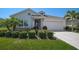 Charming single-story home with manicured landscaping, a two-car garage, and a welcoming front entrance at 11713 Chevelon Ln, Parrish, FL 34219