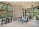 A game room features a ping pong table and cozy seating with tree views at 11713 Chevelon Ln, Parrish, FL 34219