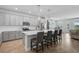 Modern kitchen with a spacious island, seating, stainless steel appliances, and elegant pendant lighting at 11713 Chevelon Ln, Parrish, FL 34219