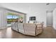 Comfortable living room with a beige sectional sofa, large sliding glass doors with beautiful views at 11713 Chevelon Ln, Parrish, FL 34219