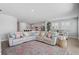 Bright and airy living room featuring a large sectional sofa, open layout, and stylish decor at 11713 Chevelon Ln, Parrish, FL 34219