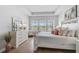 Serene main bedroom with tray ceiling, neutral decor, lots of natural light, and hard wood floors at 11713 Chevelon Ln, Parrish, FL 34219
