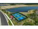 Aerial view of fenced pickleball courts, near lake and shelter provides outdoor recreational opportunities at 11713 Chevelon Ln, Parrish, FL 34219