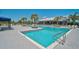 Resort-style pool area with clear blue water and lush landscaping; perfect for relaxation and community fun at 11713 Chevelon Ln, Parrish, FL 34219