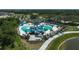 Aerial view of community pool with slides, tables, and lush landscaping perfect for hot summer days at 11713 Chevelon Ln, Parrish, FL 34219