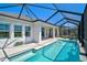 Gorgeous in-ground pool with a screened enclosure and an outdoor living space at 11713 Chevelon Ln, Parrish, FL 34219