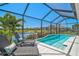 Relaxing screened-in pool overlooking a serene lake, perfect for outdoor enjoyment and waterfront views at 11713 Chevelon Ln, Parrish, FL 34219