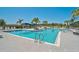 Inviting community pool featuring a beach entry, cool blue water, and ample lounge seating at 11713 Chevelon Ln, Parrish, FL 34219