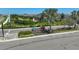 Community entrance featuring a 'Riverfield' sign surrounded by landscaping, set against homes at 11713 Chevelon Ln, Parrish, FL 34219