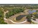 Aerial view of a winding path around a lake surrounded by lush greenery at 12014 Beeflower Dr, Lakewood Ranch, FL 34202