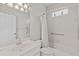 Bathroom with a combination tub and shower, white tile and grab bars for accessibility at 12014 Beeflower Dr, Lakewood Ranch, FL 34202