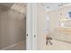 Bright bathroom featuring a double sink vanity, and a large walk-in closet with built-in shelving at 12014 Beeflower Dr, Lakewood Ranch, FL 34202