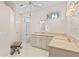 Bright bathroom featuring a walk in shower, white vanity, and decorative mirrors with ample lighting at 12014 Beeflower Dr, Lakewood Ranch, FL 34202