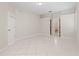 Neutral bedroom featuring neutral walls, tile flooring, closet with door and adjoining bathroom at 12014 Beeflower Dr, Lakewood Ranch, FL 34202