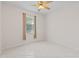 Neutral bedroom featuring tile flooring, ceiling fan, and a window with natural light at 12014 Beeflower Dr, Lakewood Ranch, FL 34202
