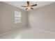 Neutral bedroom featuring tile flooring, ceiling fan, and a window with natural light at 12014 Beeflower Dr, Lakewood Ranch, FL 34202