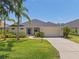 Charming single-story home with a well-manicured lawn and two-car garage at 12014 Beeflower Dr, Lakewood Ranch, FL 34202