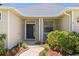 Close-up of the front door with charming landscaping and a well-maintained walkway to the home at 12014 Beeflower Dr, Lakewood Ranch, FL 34202