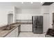 Well-equipped kitchen features white cabinetry, granite counters, and stainless steel appliances at 12014 Beeflower Dr, Lakewood Ranch, FL 34202