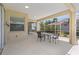 Outdoor covered lanai with seating and views of the screened in backyard and pool at 12014 Beeflower Dr, Lakewood Ranch, FL 34202