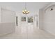 Spacious open-concept living area with bright white tile floors and a view to the outdoor patio at 12014 Beeflower Dr, Lakewood Ranch, FL 34202